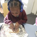 Student cutting dough