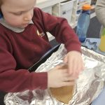 Student user mold cutter to cut dough.